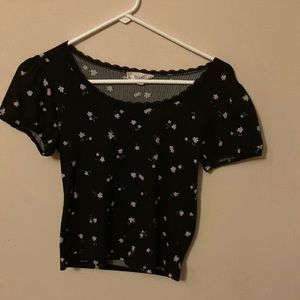 Brand pink rose color black background with small white flowers all around